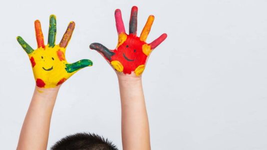 The hands of the child who smeared on the gray background.