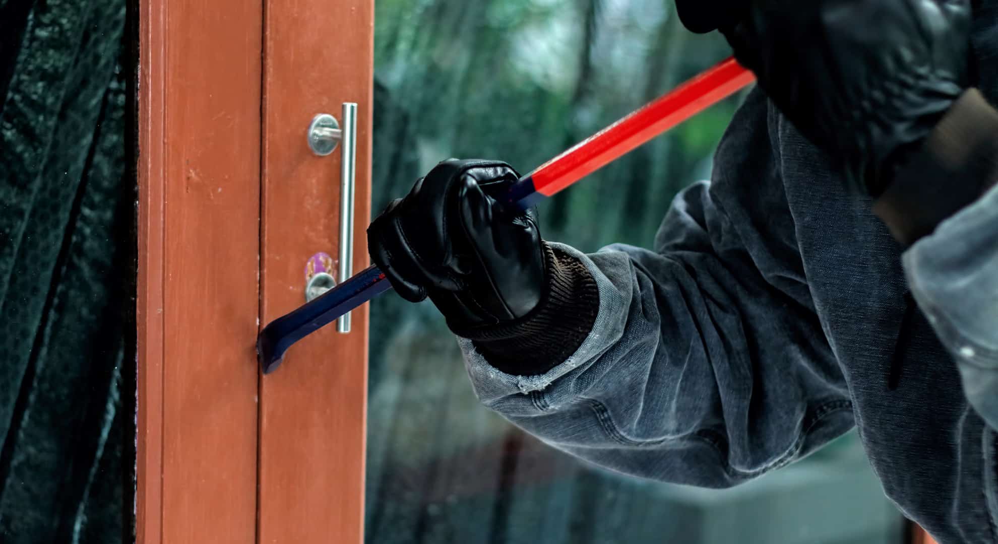 burglar-with-crowbar-trying-break-door-enter-house