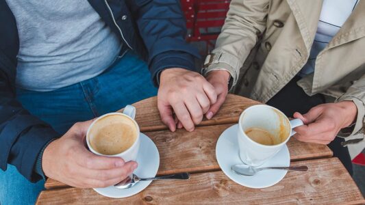 couple-holding-hands-while-drinking-latte-outdoors-cafe couple-holding-hands-while-drinking-latte-outdoors-cafe