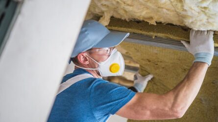 man-insulating-house