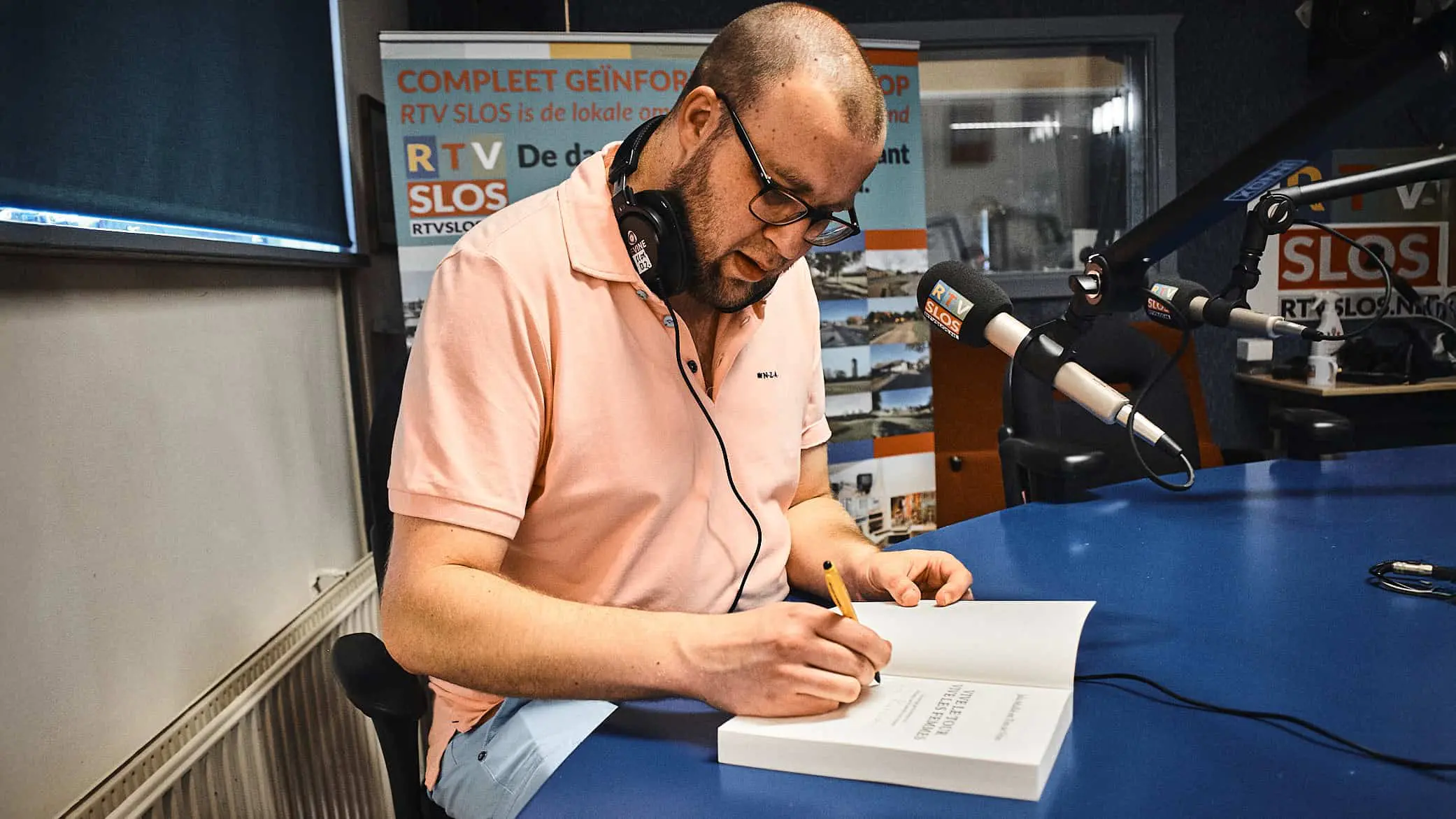 Tim de vries zet handtekening in zijn boek' Vive le Tour, Vive les Femmes' ©Yannick van den Dijssel