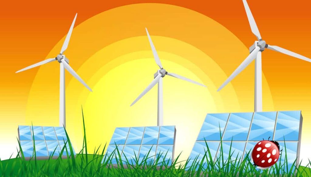 Panels with solar cells and wind generators on a green field with blue sky stock photo