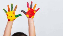 The hands of the child who smeared on the gray background.