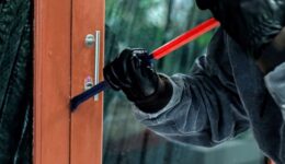 burglar-with-crowbar-trying-break-door-enter-house