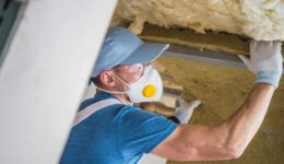 man-insulating-house
