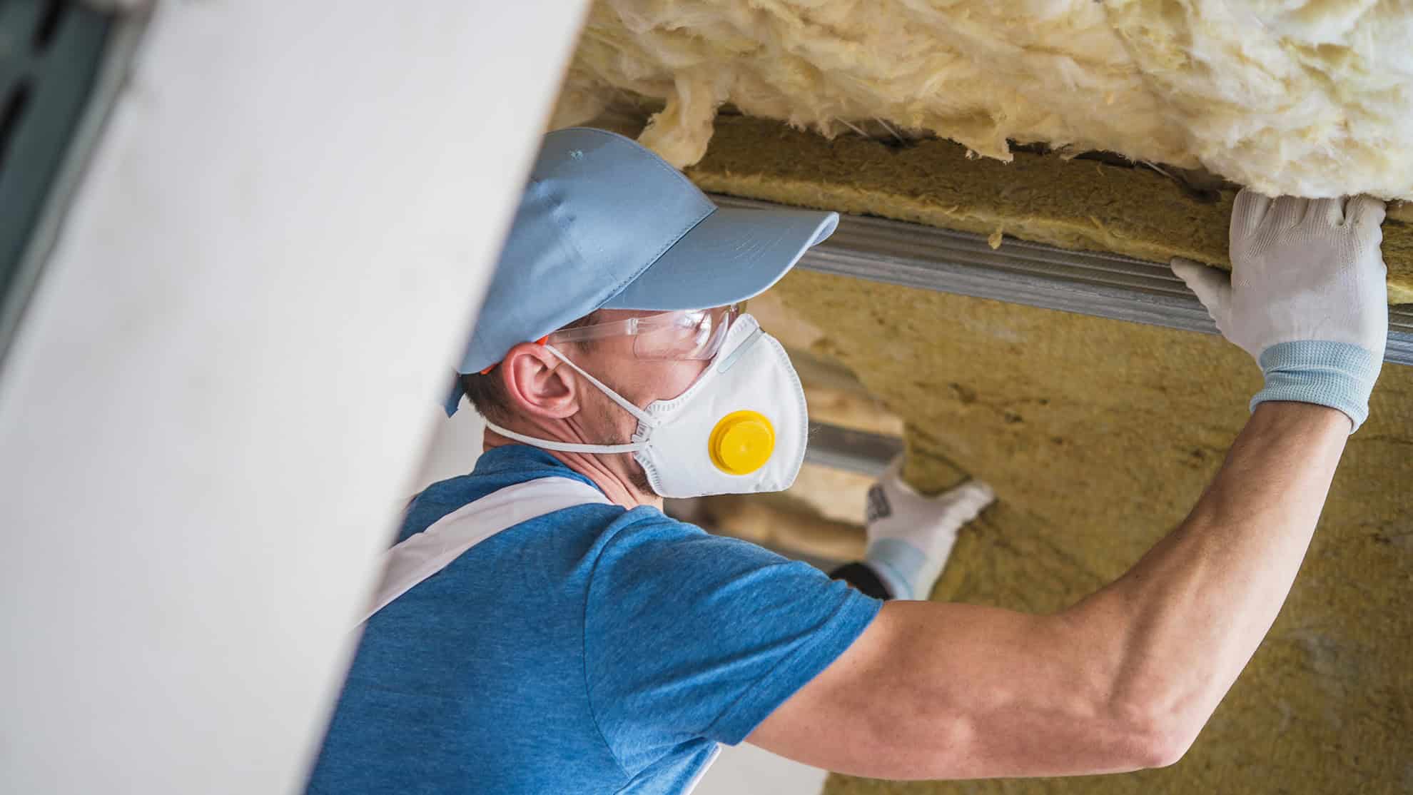 man-insulating-house